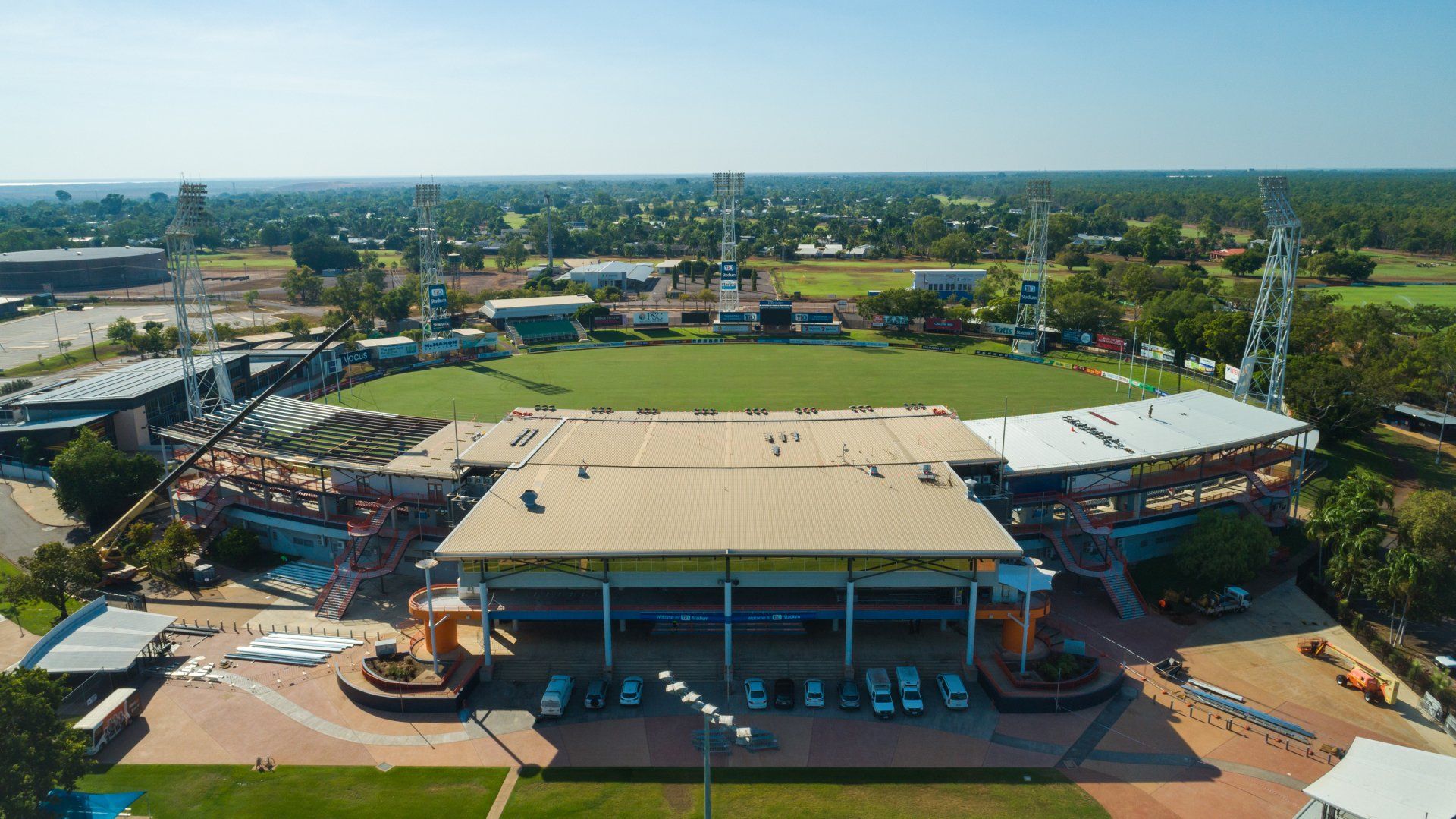 An aerial view of a large stadium surrounded by trees and grass.