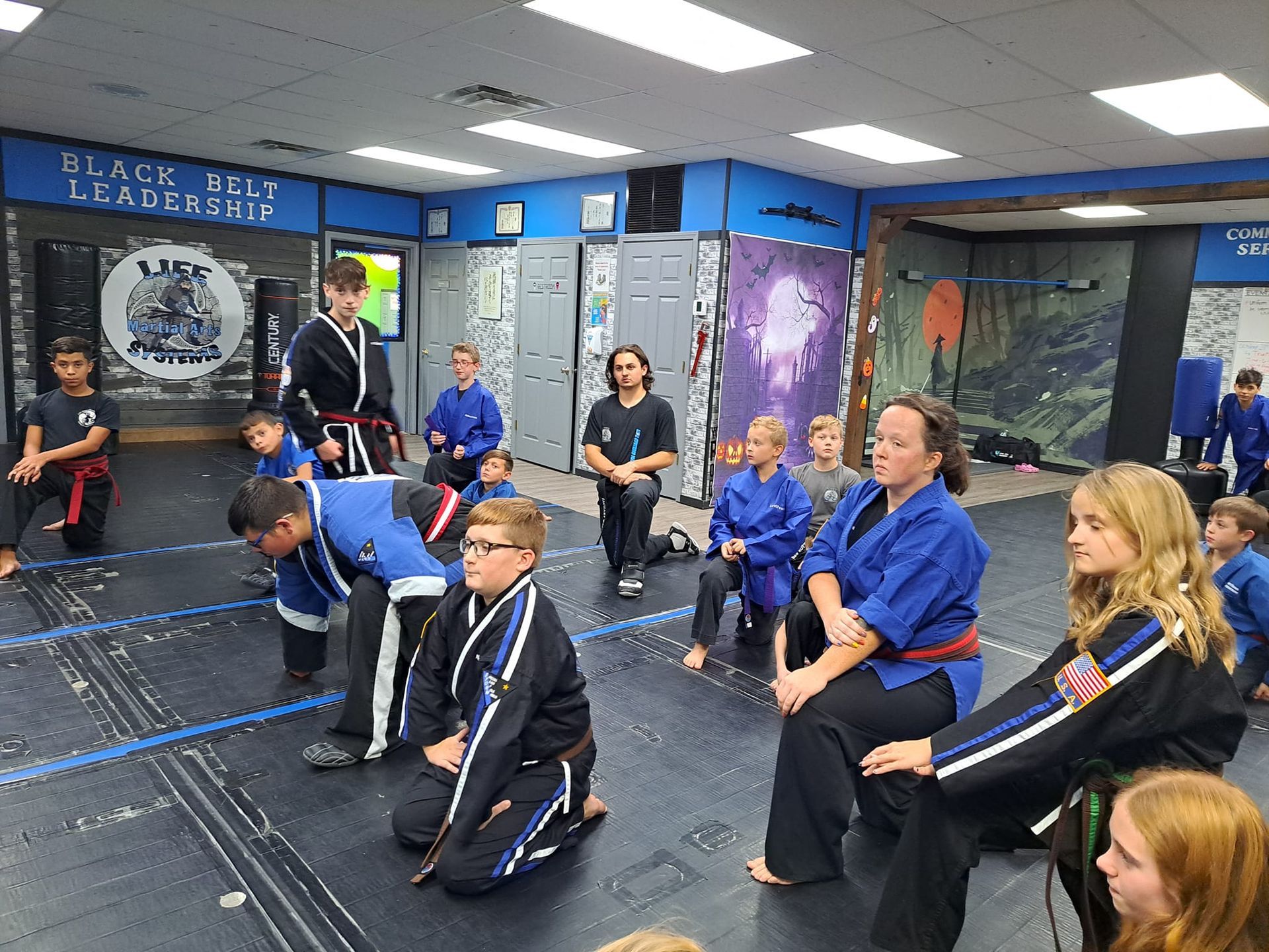 A group of people holding sticks in a gym.