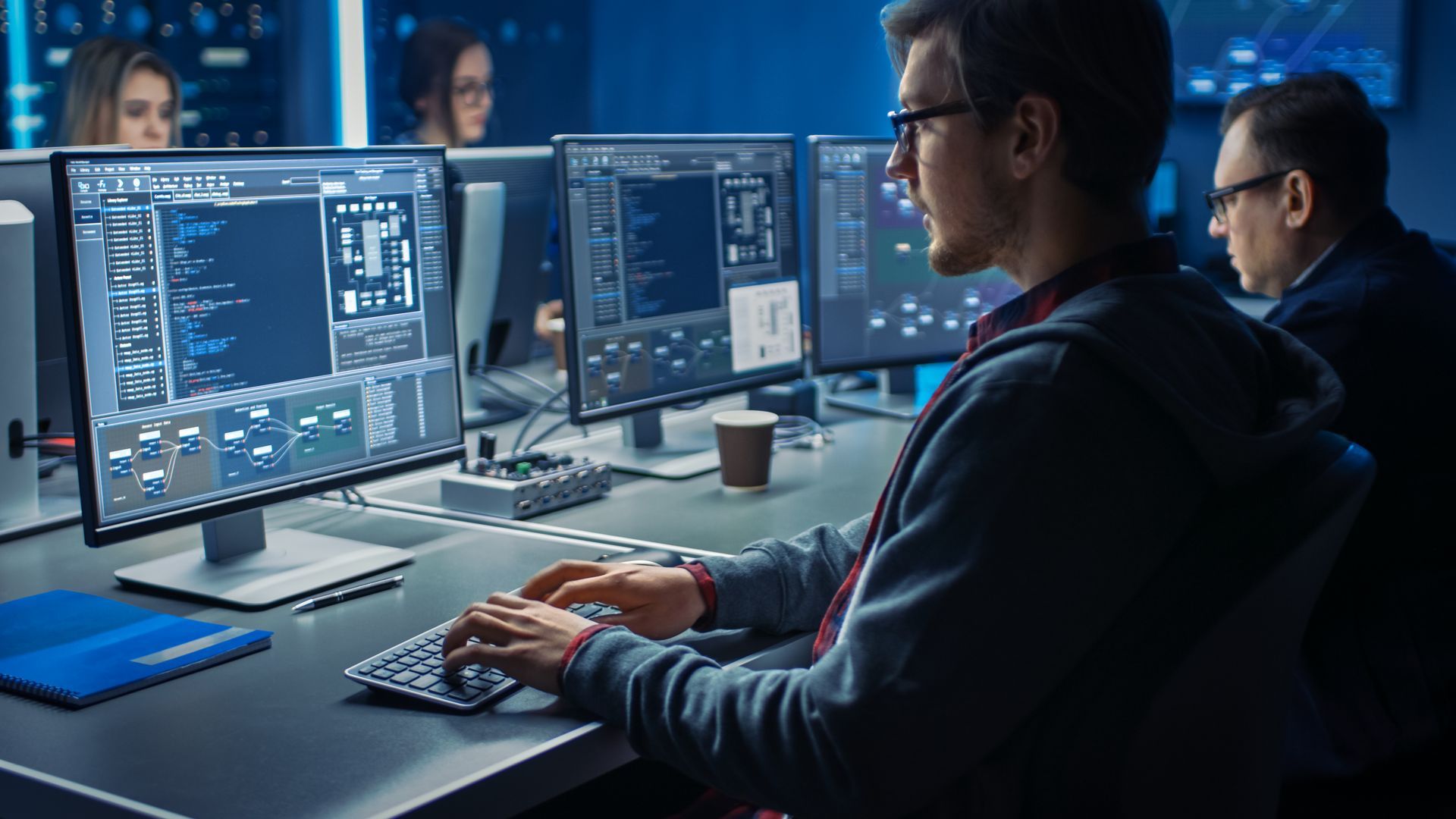 a man is sitting at a desk in front of a computer .