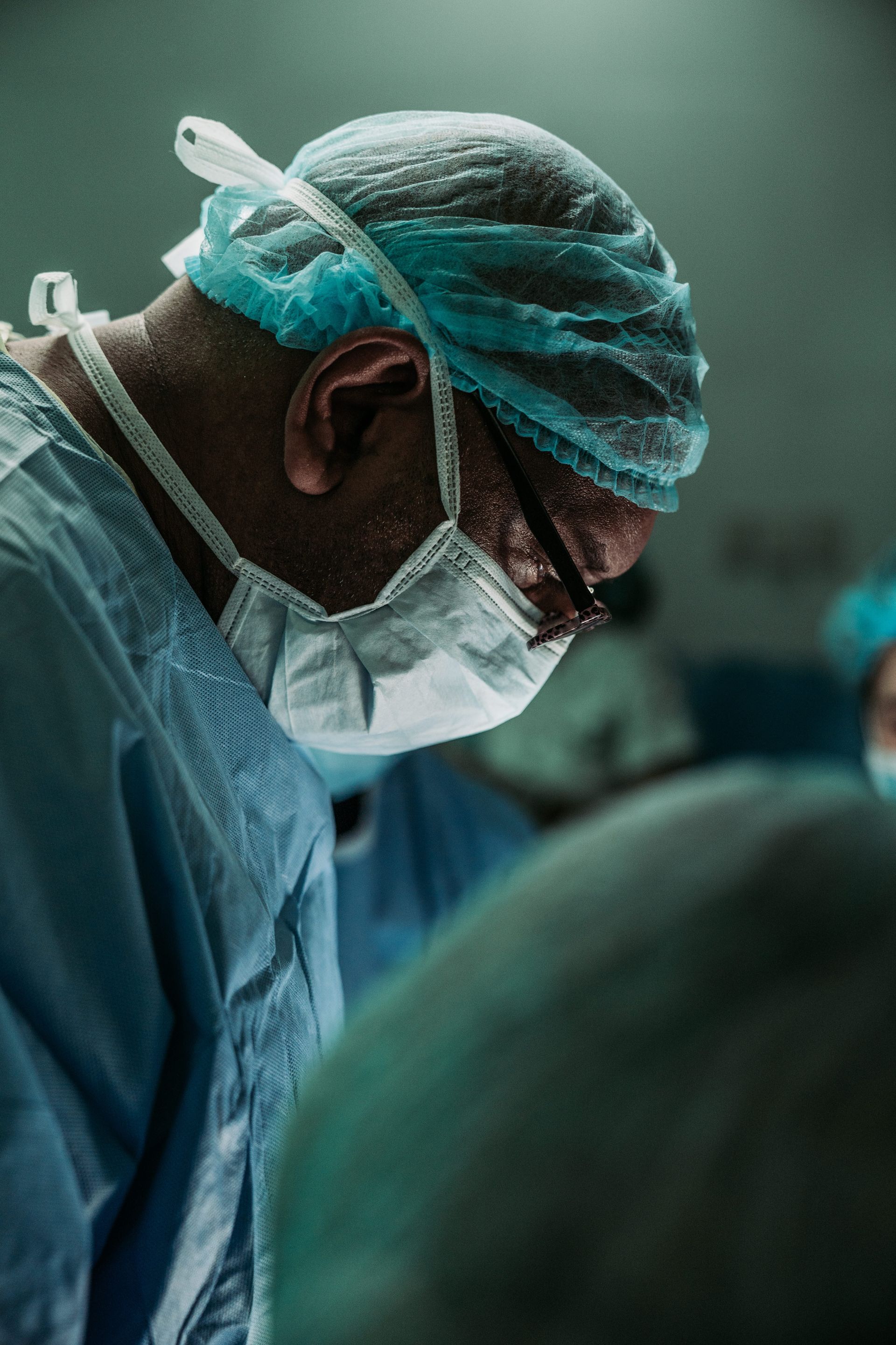 Doctor with mask and blue surgical performing surgery