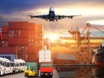 an airplane is flying over a warehouse with containers and trucks .