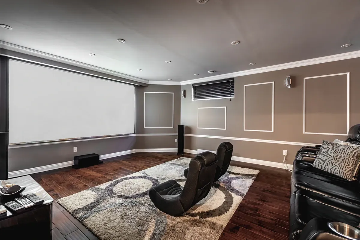 Waterproof laminate basement flooring over concrete in an entertainment room.