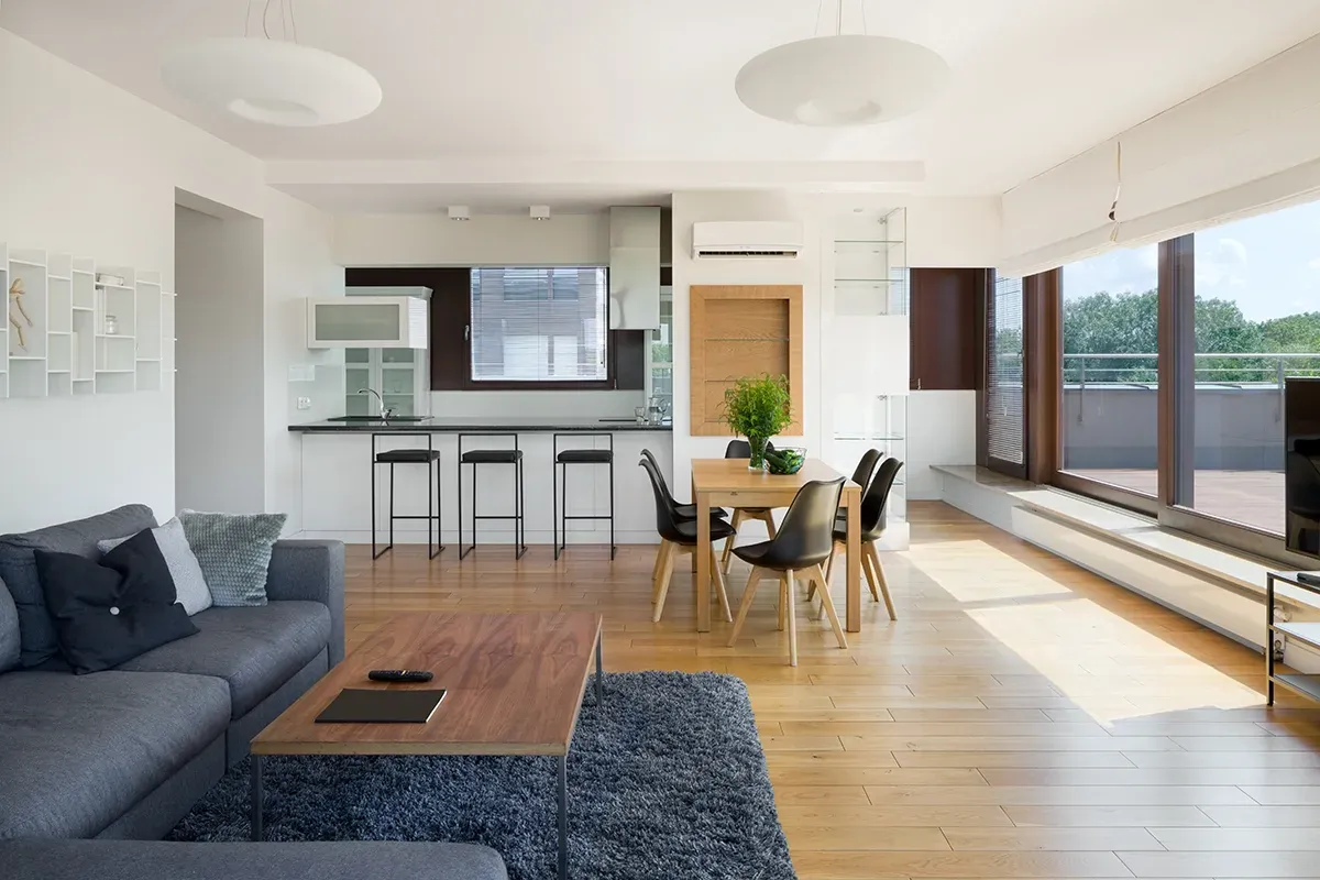 Laminate, the best flooring for rental property, installed in a large open format apartment.