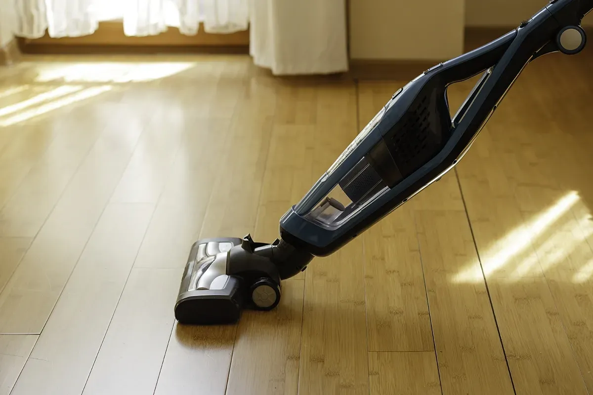 Using a vacuum to clean bamboo flooring.