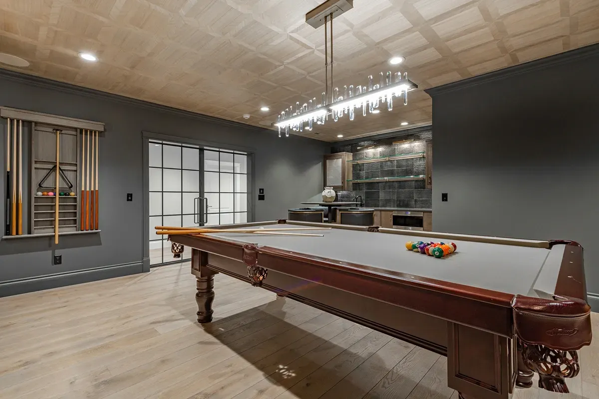 Concrete basement flooring in a billiards room.