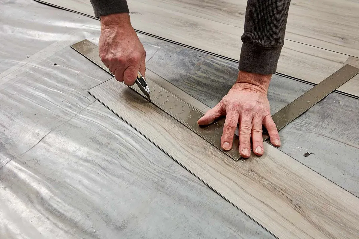 Cutting vinyl plank flooring to make room for obstacles.