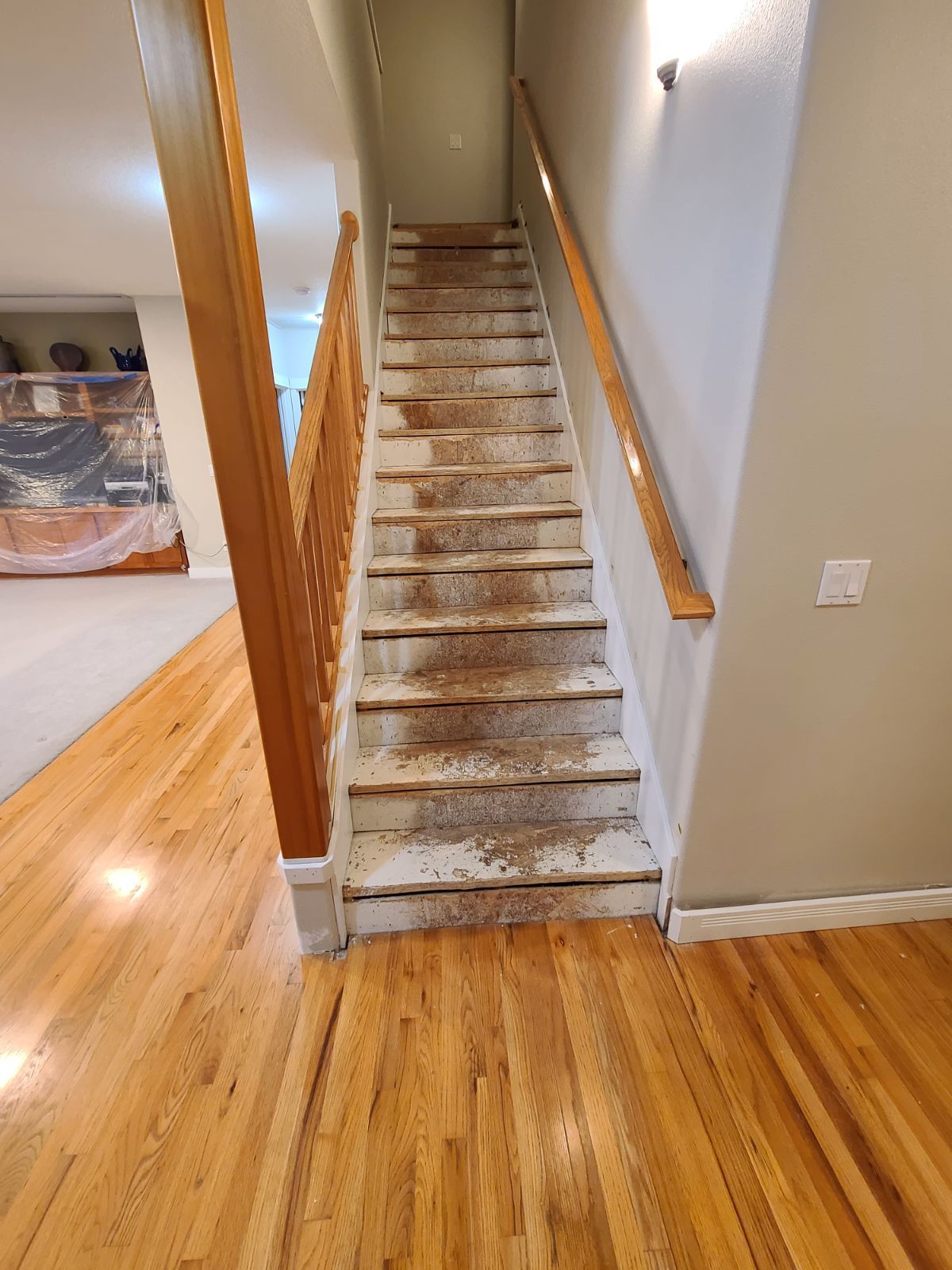 Old flooring on stairs before new flooring installation.