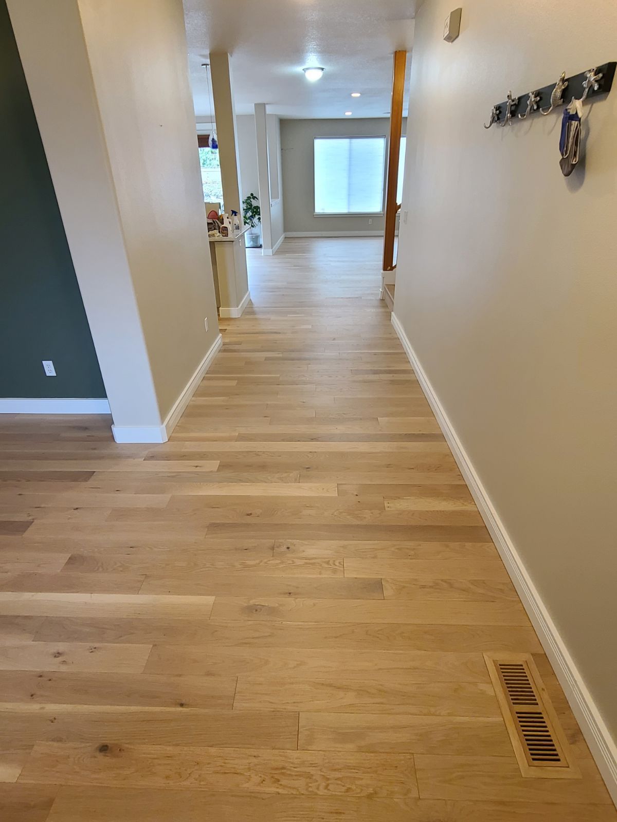 New white oak hardwood floors in the hallway.