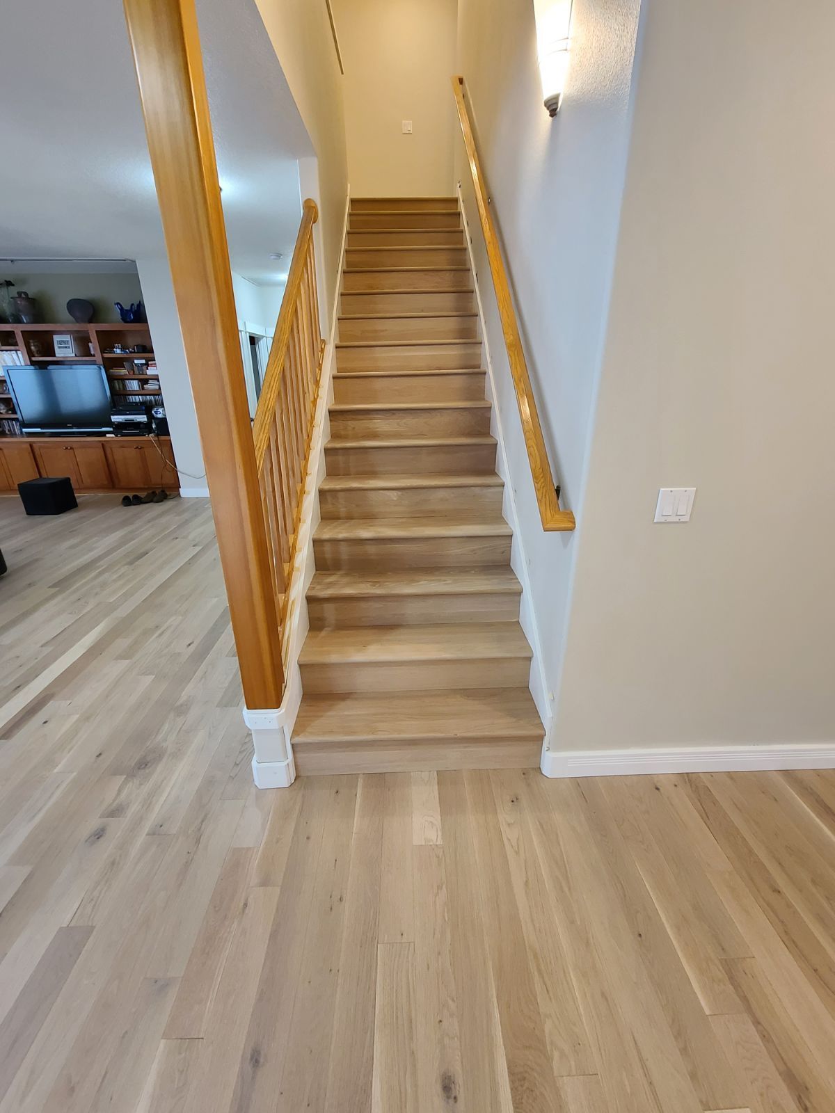 White oak hardwood flooring on stairs after installation.