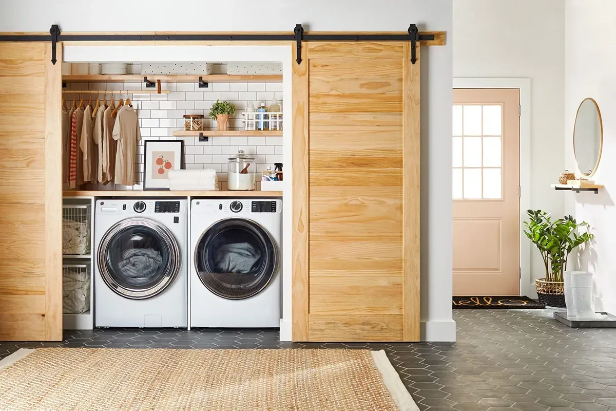 Neatly organized laundry room with new flooring.