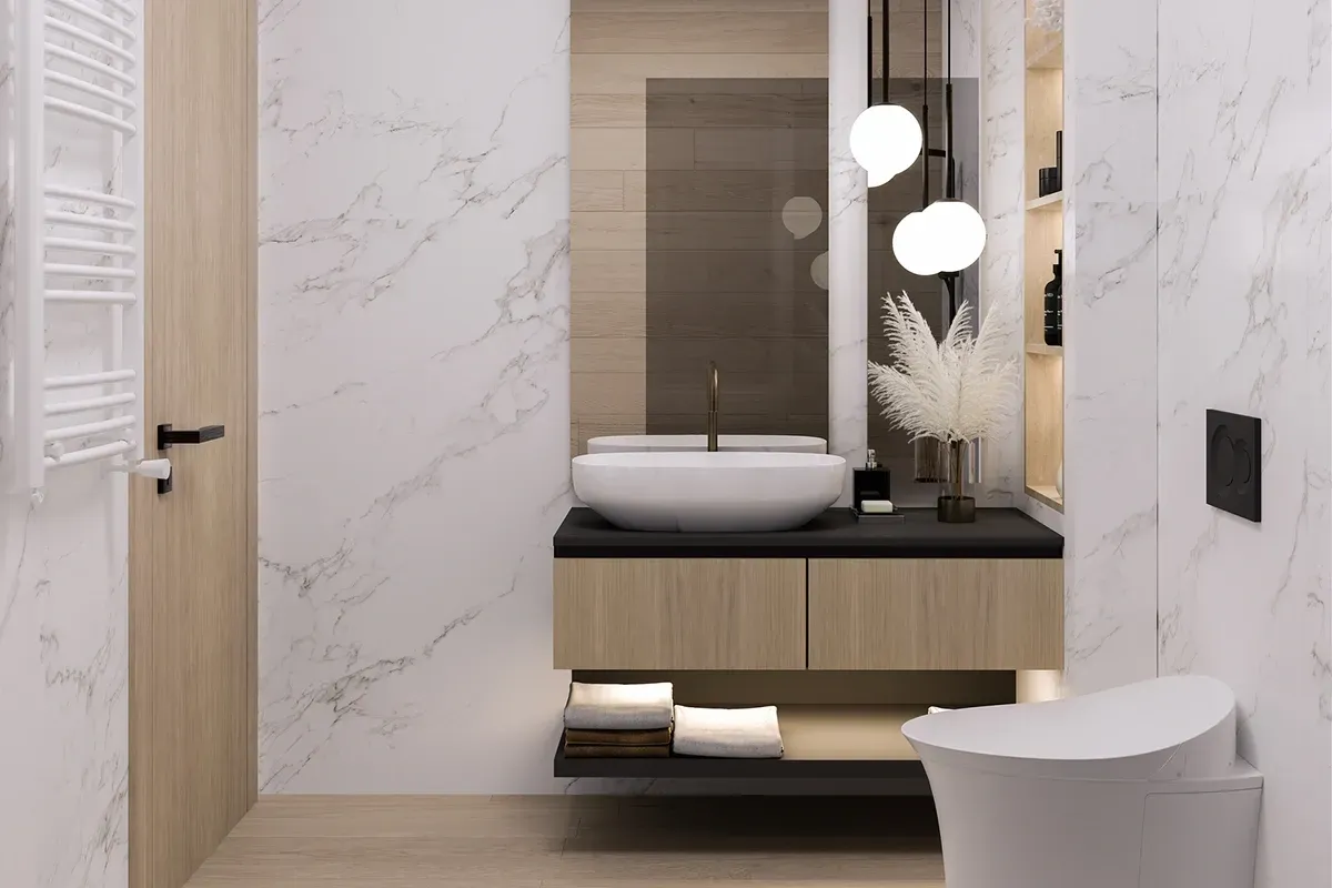 Natural wood look LVP flooring in a small modern bathroom with natural wood accents and white marble walls.