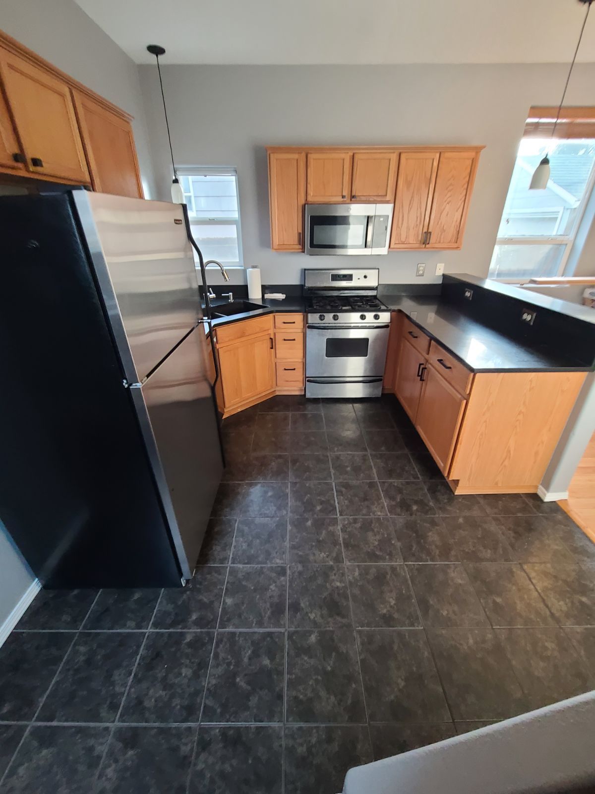 Kitchen before installation of hardwood flooring for high traffic areas.