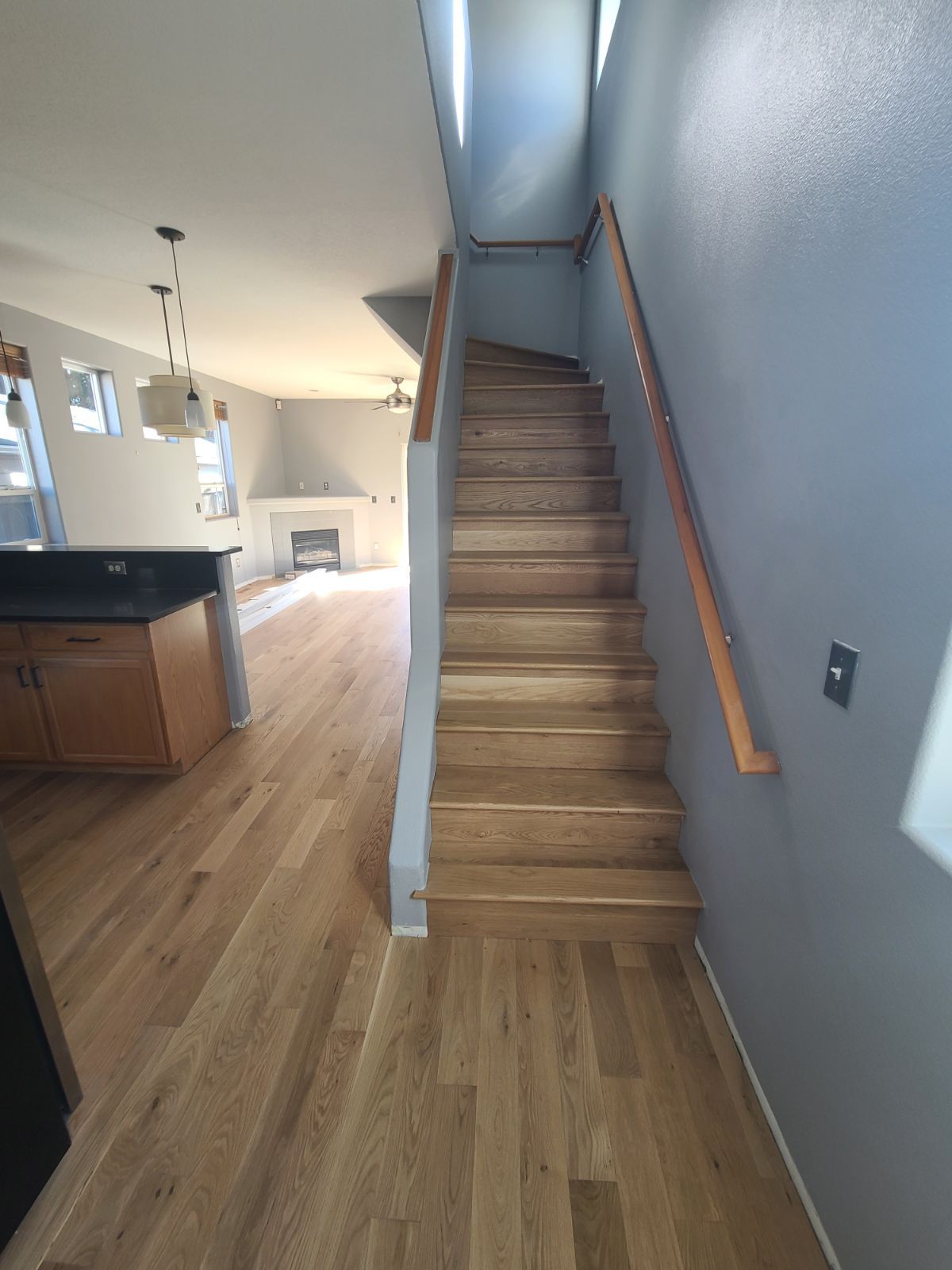 Staircase after installation of hardwood flooring for high traffic areas.