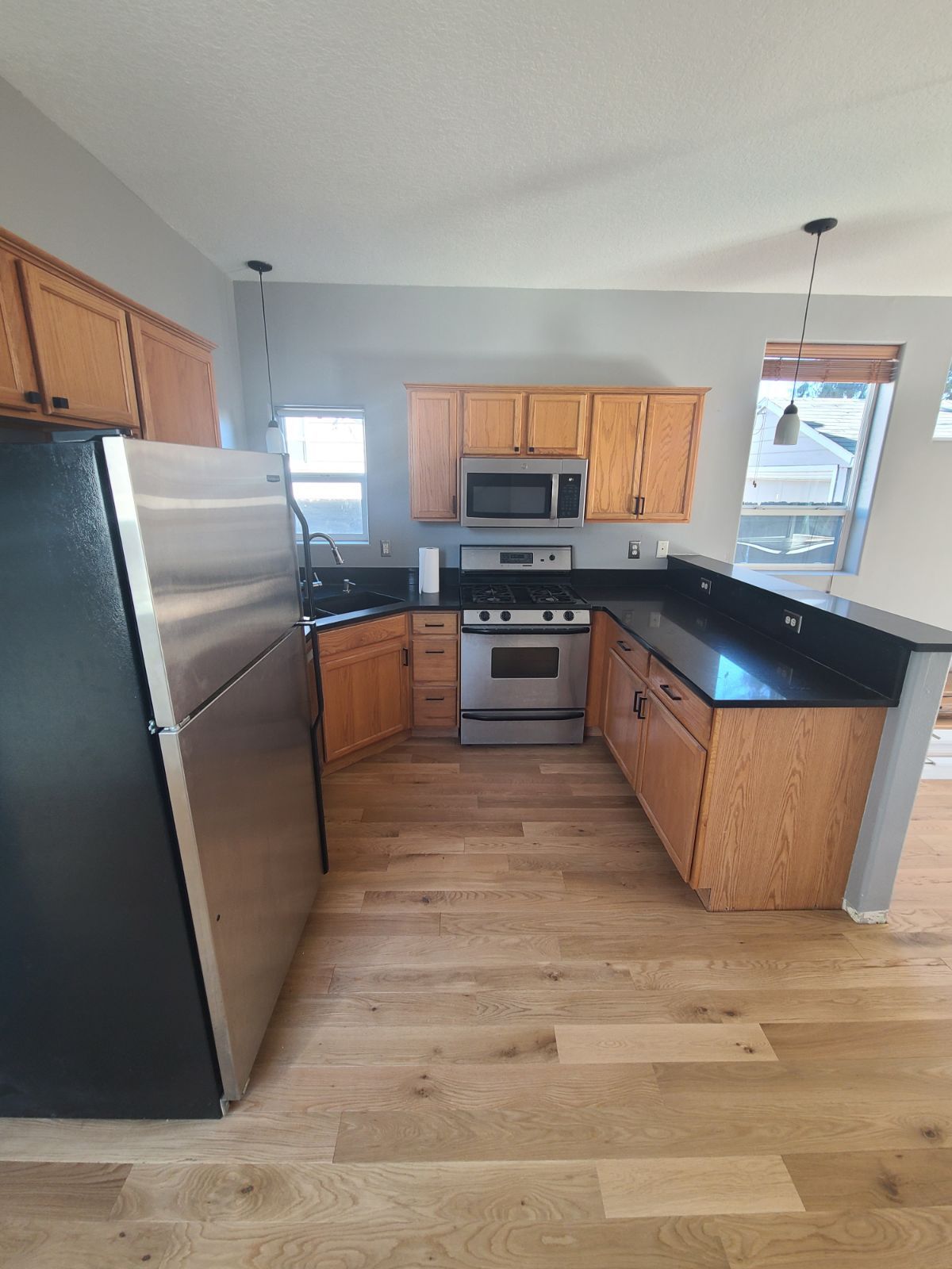 Kitchen after installation of hardwood flooring for high traffic areas.