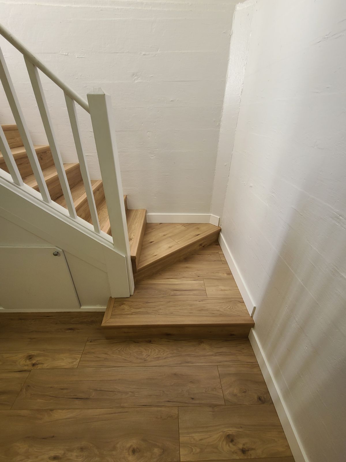 New basement laminate flooring on stairs.