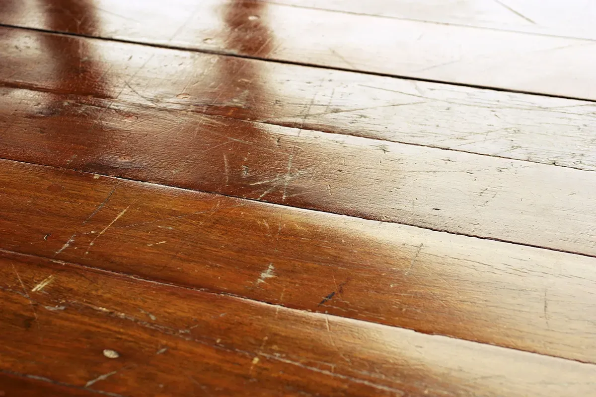 Closeup of scratched mahogany wood floors.