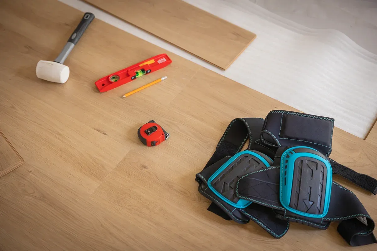 Flooring tools scattered on the ground.
