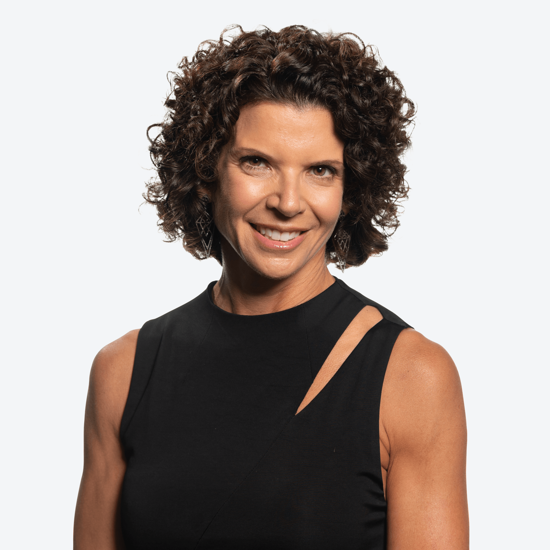 A woman with curly hair is wearing a black tank top