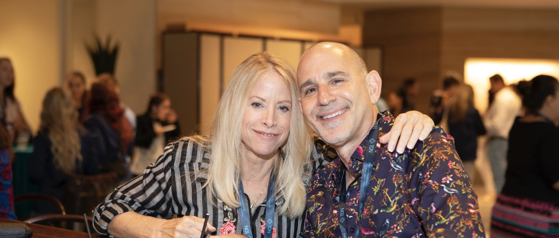 A man and a woman are posing for a picture at a party.