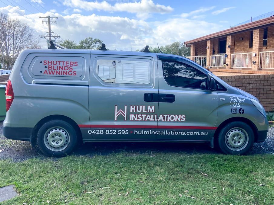 A Silver Van Is Parked In Front Of A House  — Solis Signs in Toukley, NSW
