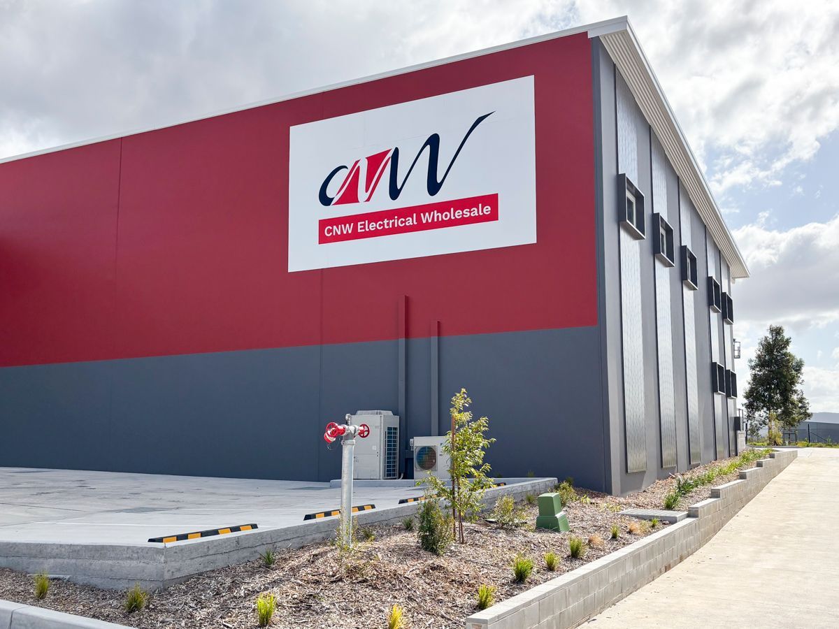 A large building with a sign on the side that says aw— Solis Signs in Toukley, NSW