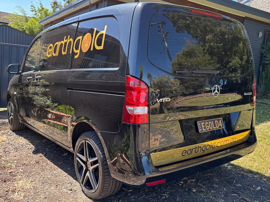 A Black Van Is Parked In Front Of A House  — Solis Signs in Toukley, NSW