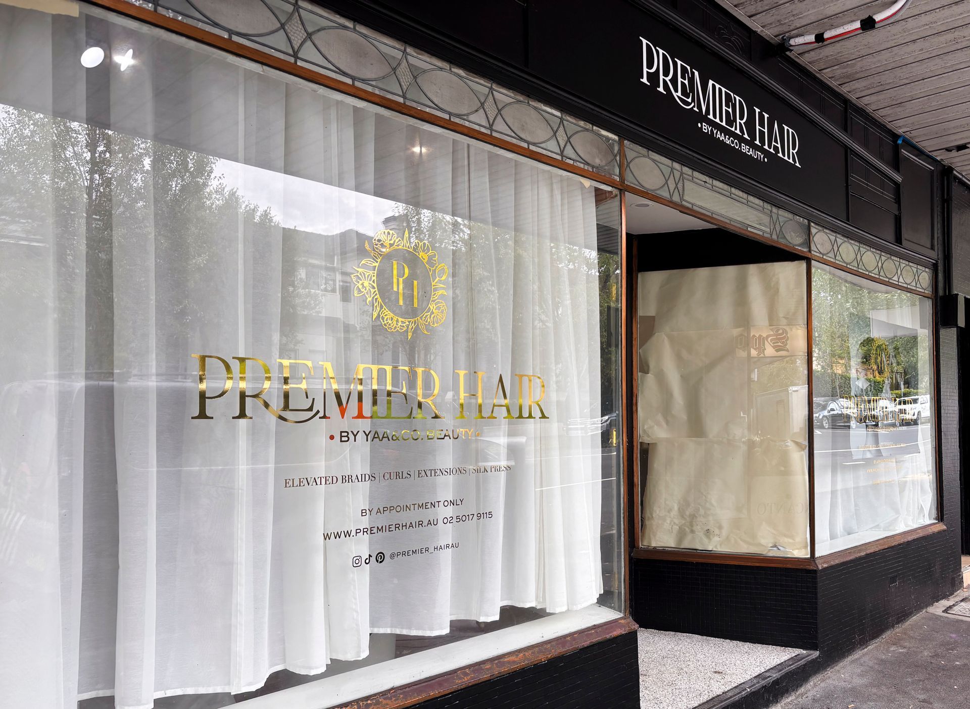 A store front with a sign that says premier on it   — Solis Signs in Toukley, NSW