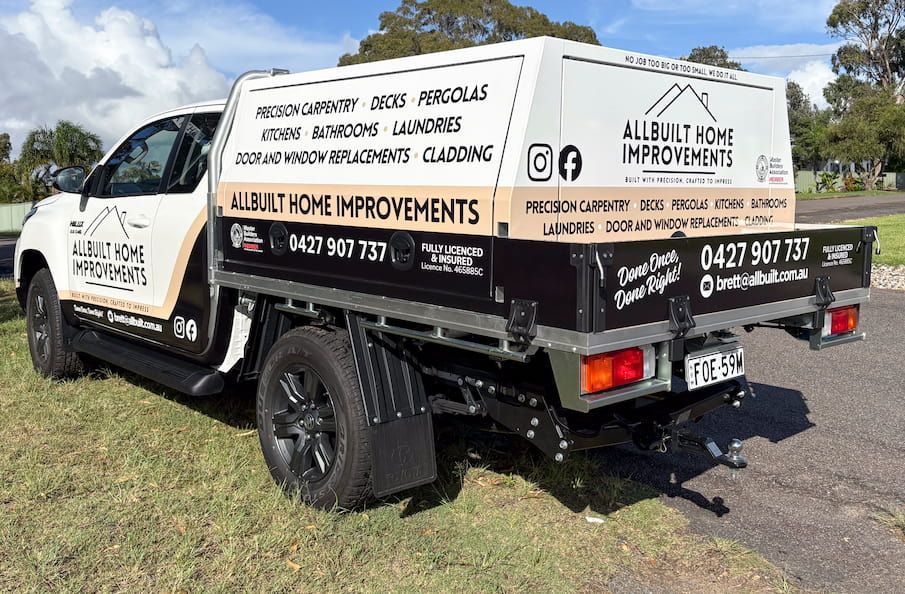 A White And Black Truck Is Parked On The Side Of The Road  — Solis Signs in Toukley, NSW