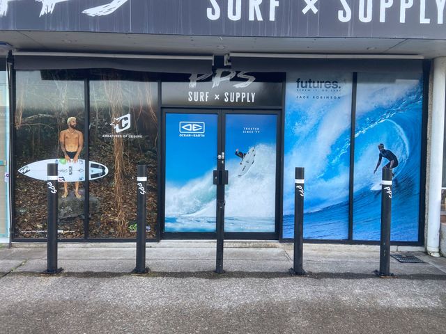Shop front with marketing adhesives on the shop window — Solis Signs in Toukley, NSW
