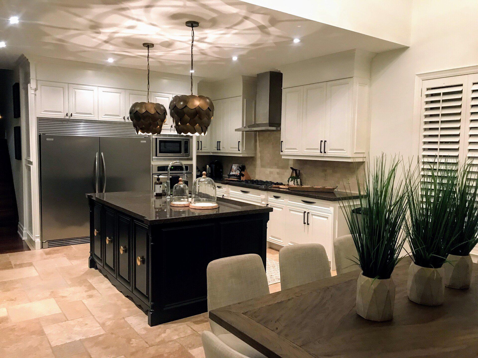 A kitchen with a large island and a dining table