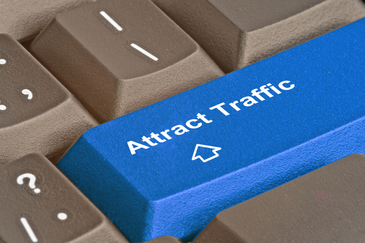 A keyboard featuring the phrase 'Attract Traffic,' highlighting the benefits of link building for your business.