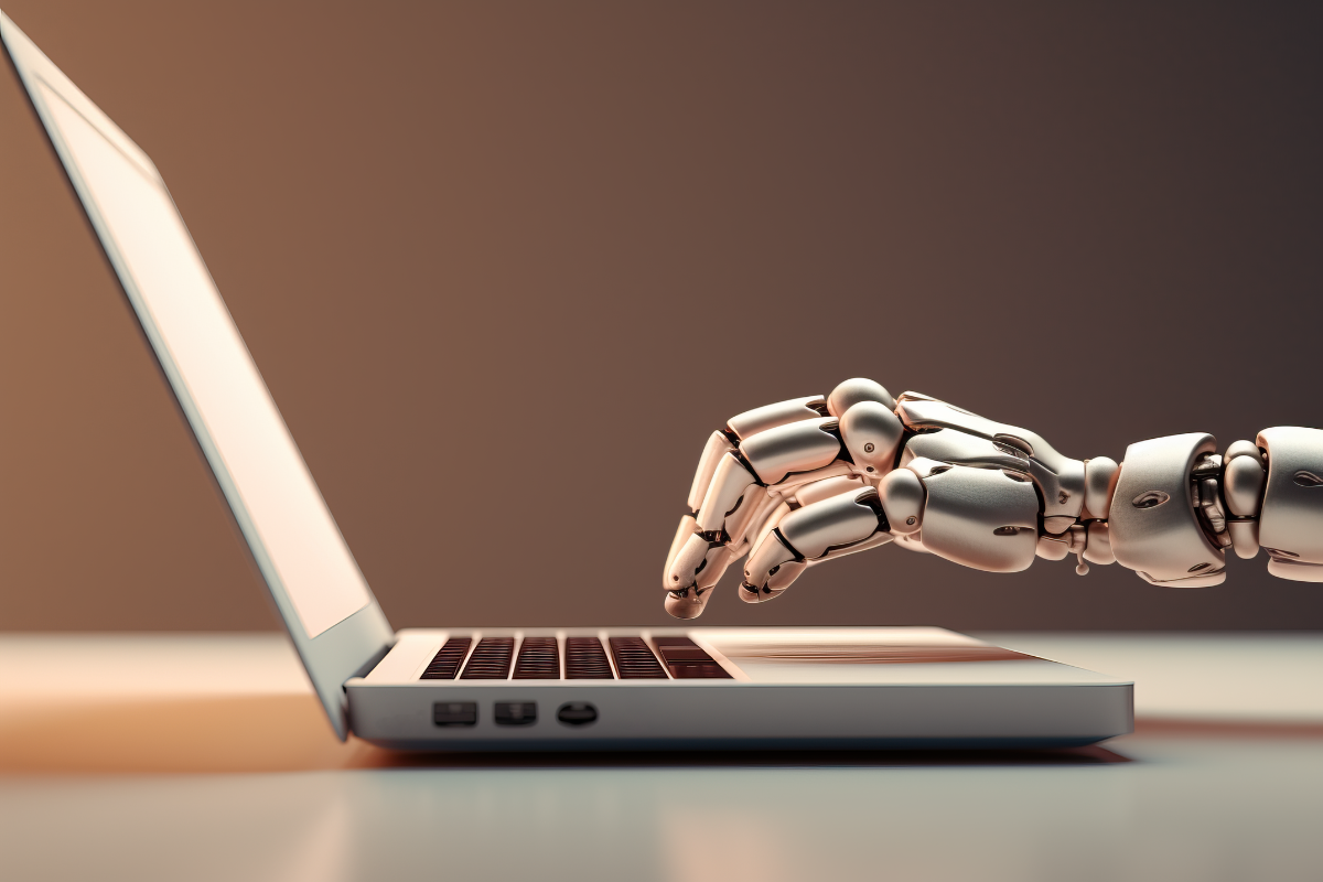 Robotic hand typing on a laptop, symbolizing the integration of AI and automation in adaptive SEO trends.