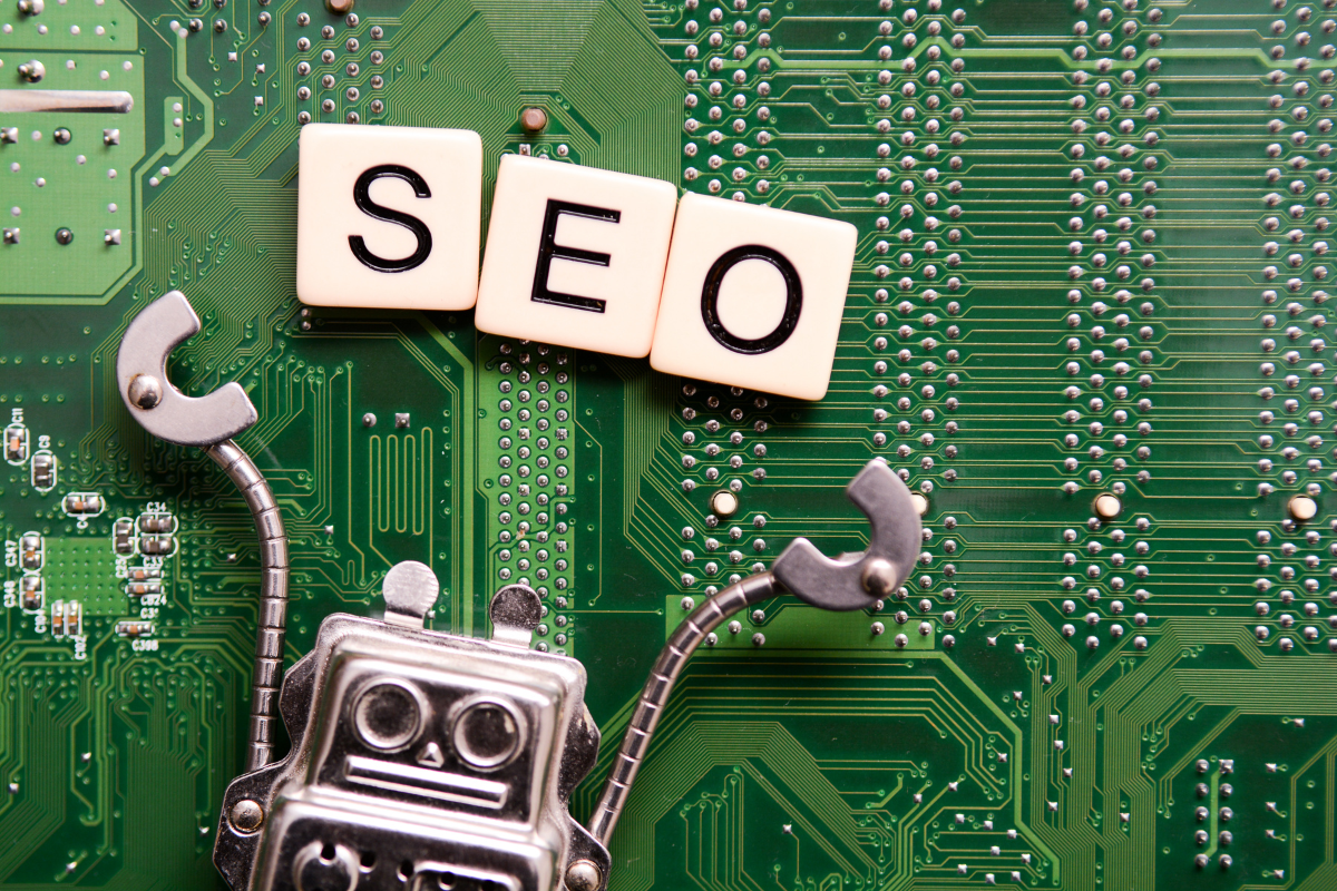 Robot with 'SEO' blocks on a circuit board, symbolizing SEO trends and tech-driven strategies.