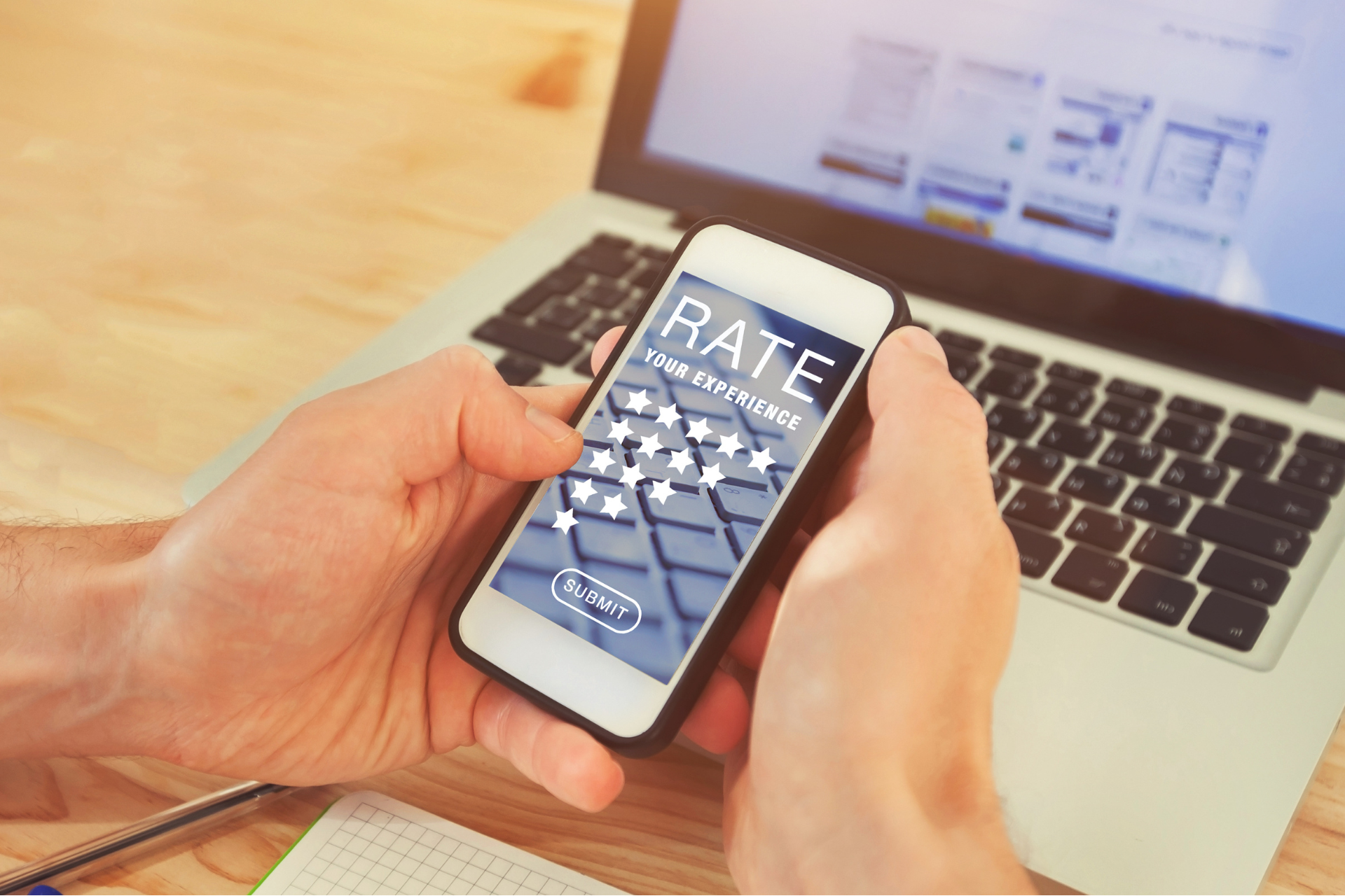 A person using a phone to submit a rating, representing how reputation management services track and improve customer feedback.