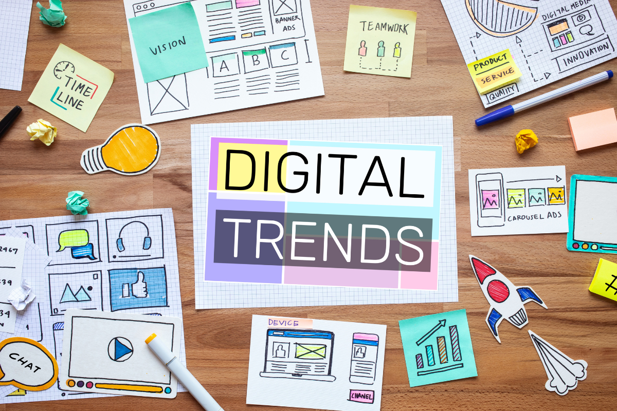 Creative desk setup with charts, notes, and sketches around 'DIGITAL TRENDS,' highlighting SEO and content marketing strategies.