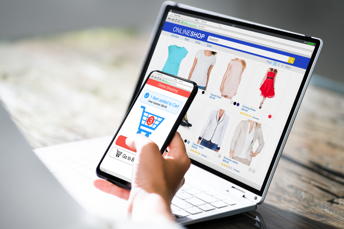 A person shopping on fast fashion websites using a laptop and smartphone, adding items to the cart for checkout.