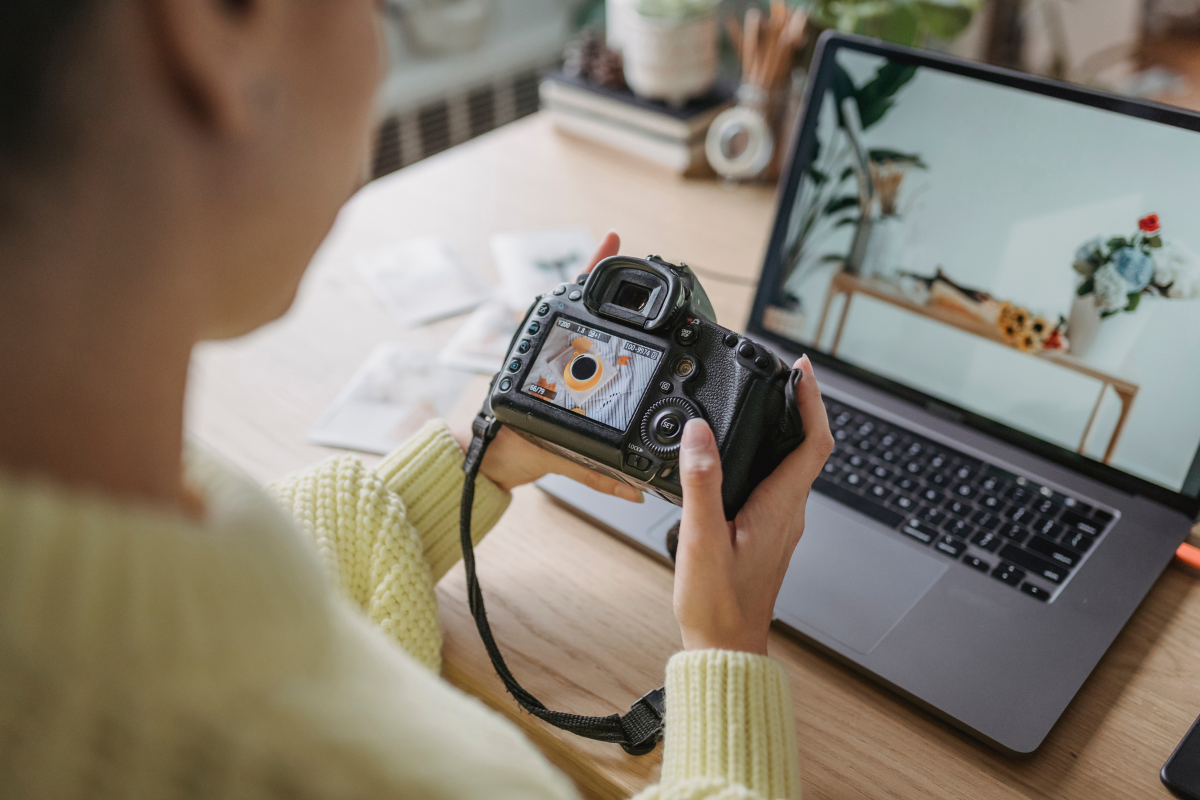 A person reviews a photo on a DSLR camera, linked to SEO for photographers and editing workflow.