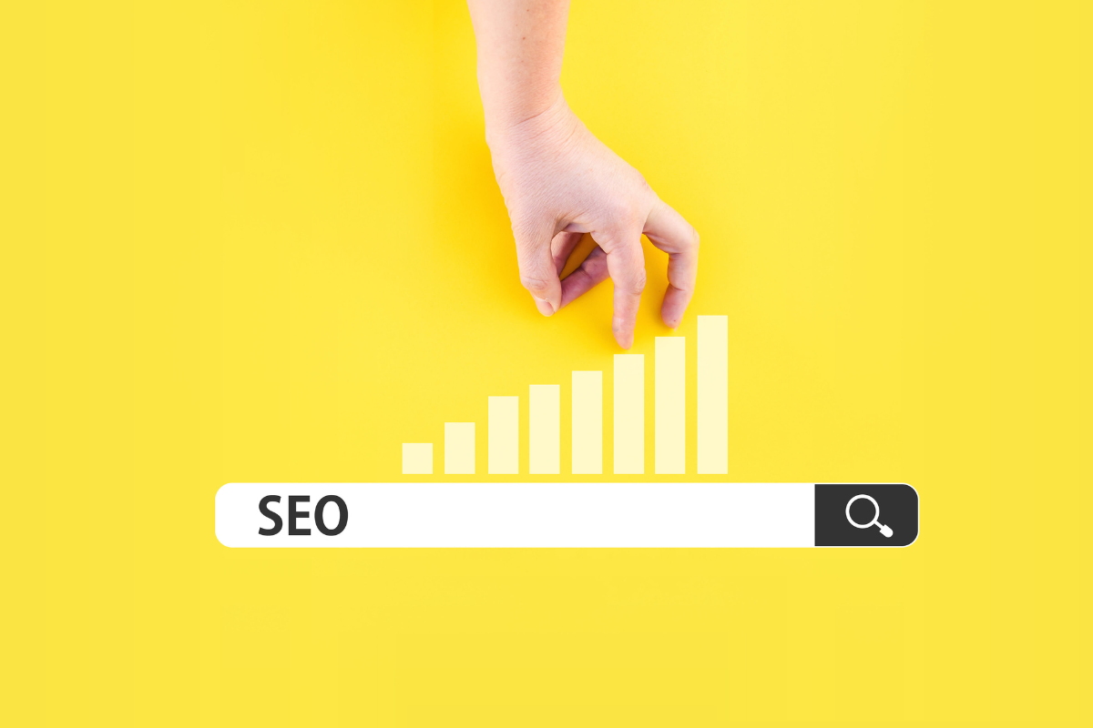 Hand climbing a bar chart on a yellow background with 'SEO' in the search bar, symbolizing growth in search engine optimization.