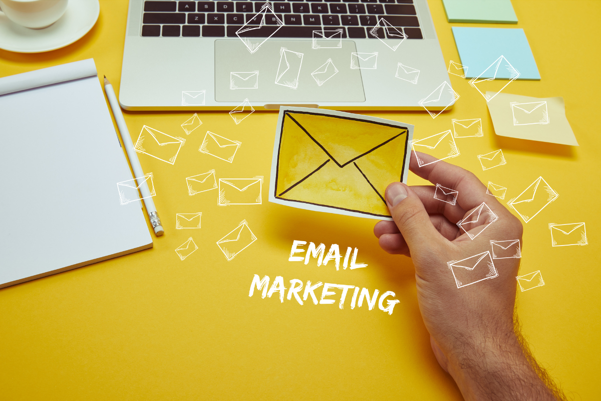 A man holding a picture of a logo related to email marketing emphasizing the importance of email campaigns in boosting conversions and driving engagement for online businesses.