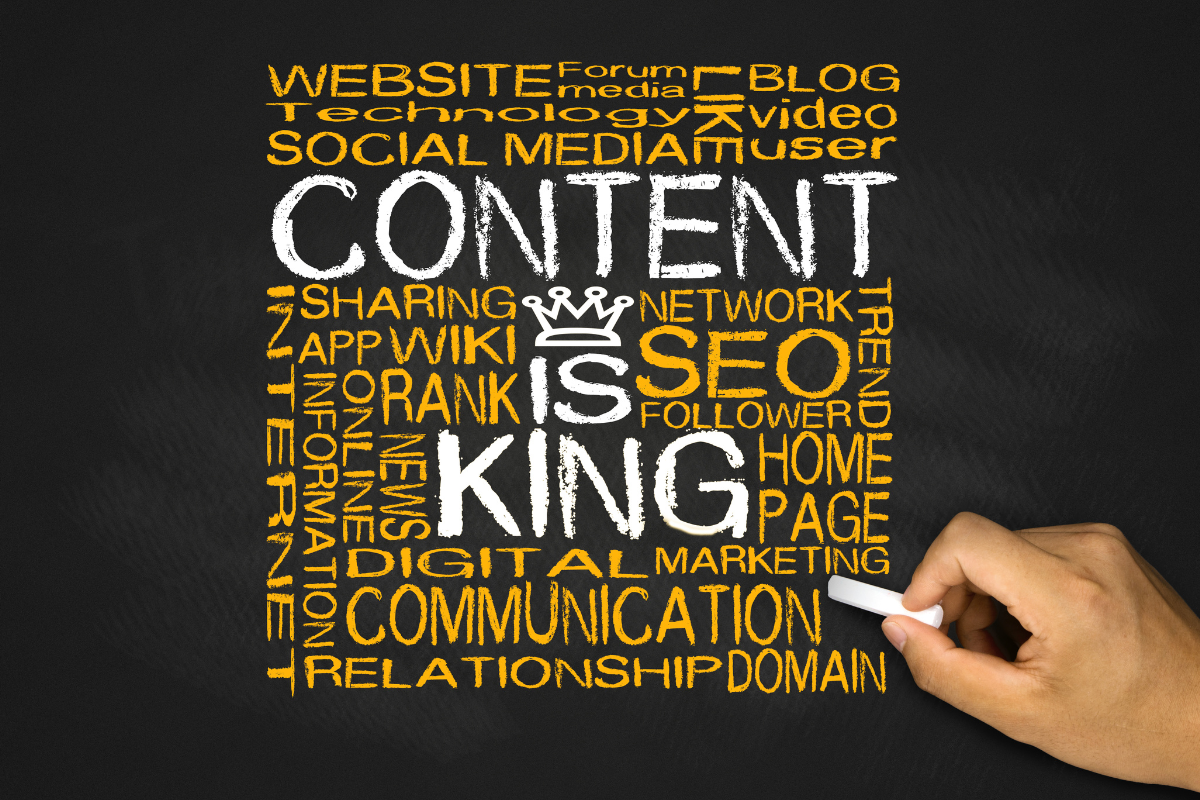 A hand writing on a blackboard with 'Content is King' surrounded by its branches, symbolizing how Visio SEO can put your content to work.