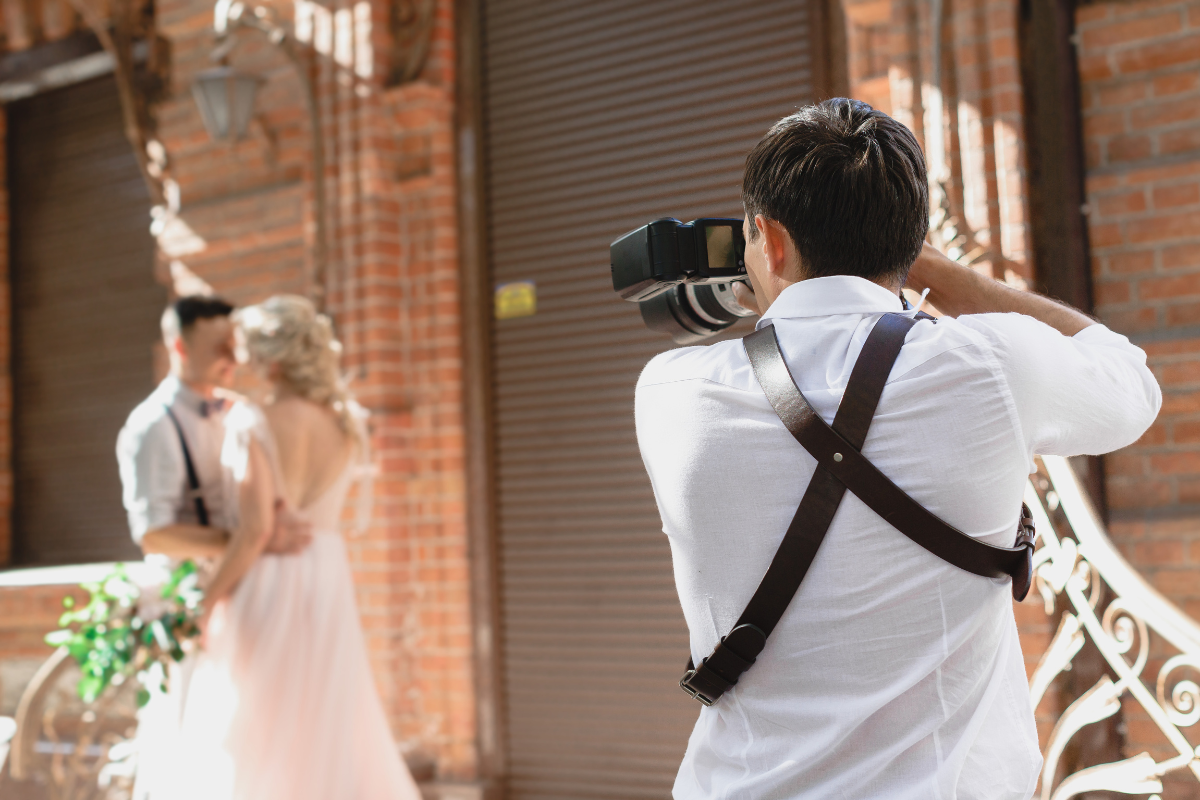 A photographer captures a wedding couple’s moment, symbolizing SEO for photographers focused on reaching clients in niche markets.