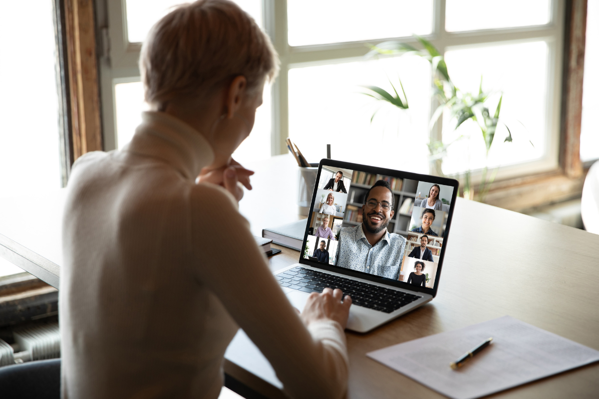 A woman participating in a video conference, illustrating the importance of engaging in online communities to strengthen and expand her online presence.