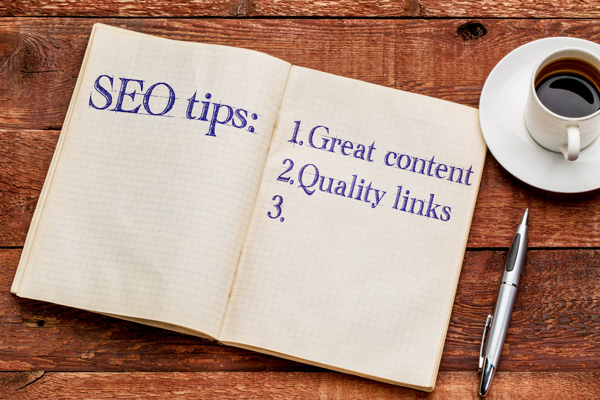 A notepad with writing next to a cup of coffee offering insights and tips on HVAC SEO strategies to improve search rankings for HVAC businesses.