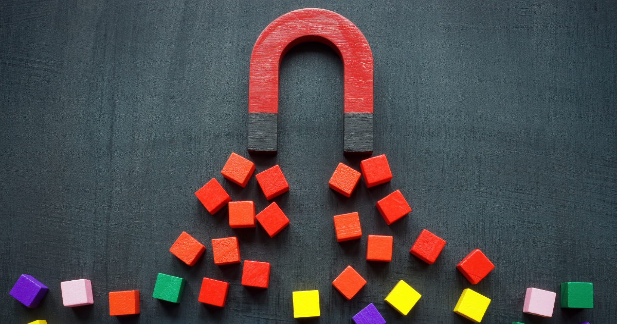 Red magnet attracting colorful blocks on a black background, symbolizing an automated lead generation tool in action.