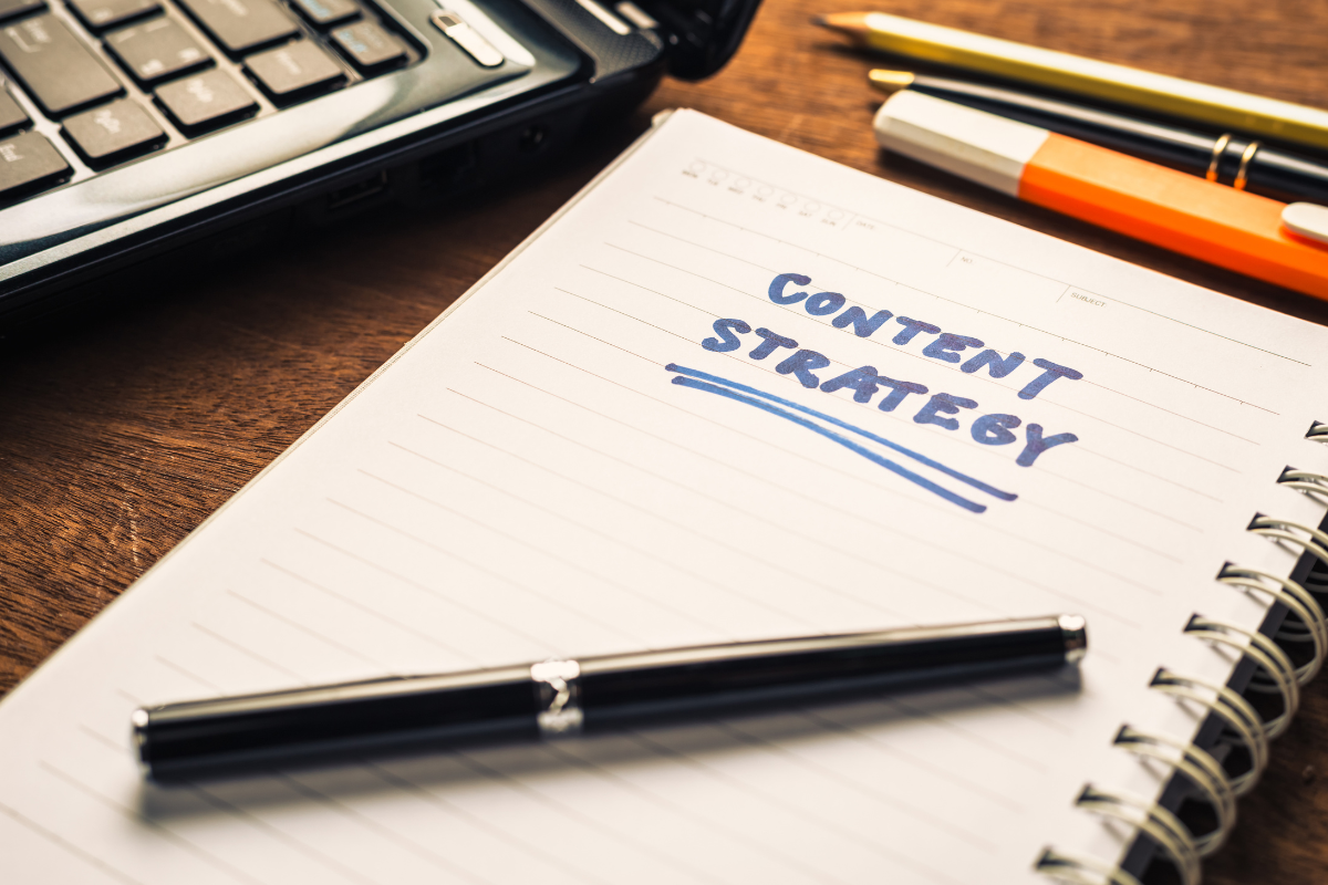 A notebook labeled 'Content Strategy,' with a pen placed on top, symbolizing the importance of keeping content fresh and relevant.
