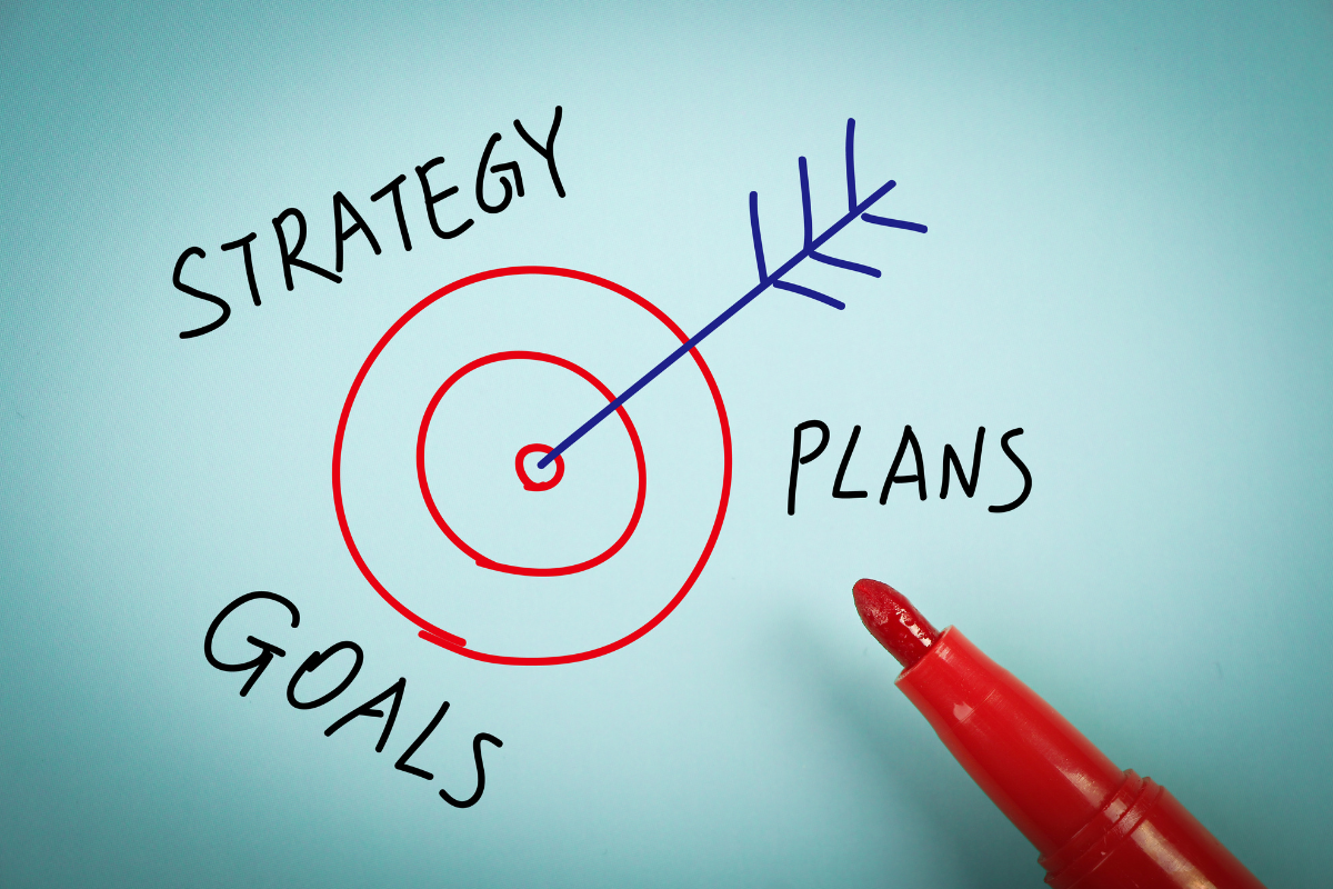 A red marker placed next to a target, surrounded by the words 'Strategy,' 'Plans,' and 'Goals,' related to reputation management strategies.