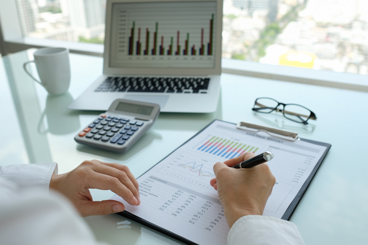 A person reviewing an SEO audit on a clipboard focusing on HVAC SEO strategies for measuring and improving website performance.