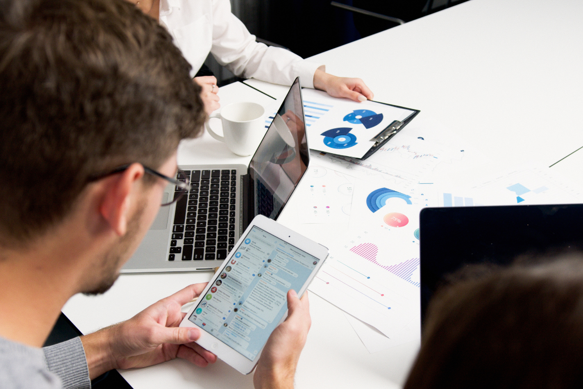 Two people engaged in a discussion, reviewing key social media engagement metrics to track for effective audience interaction and growth strategies.