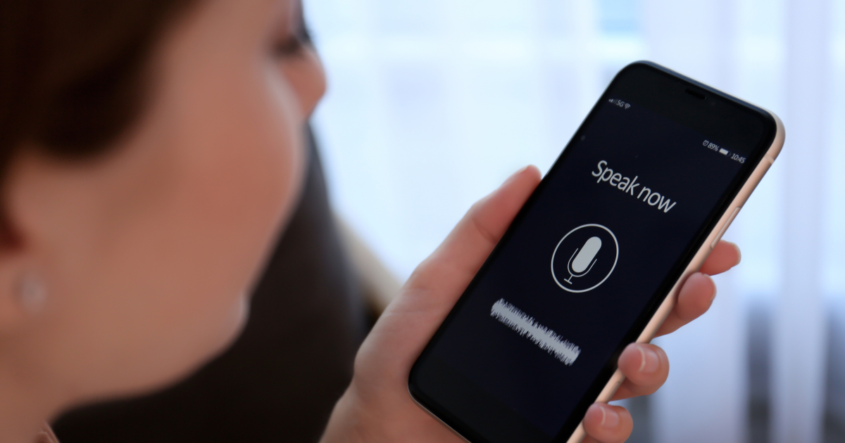 A woman using voice search on her smartphone, emphasizing the role of voice optimization in healthcare SEO​.