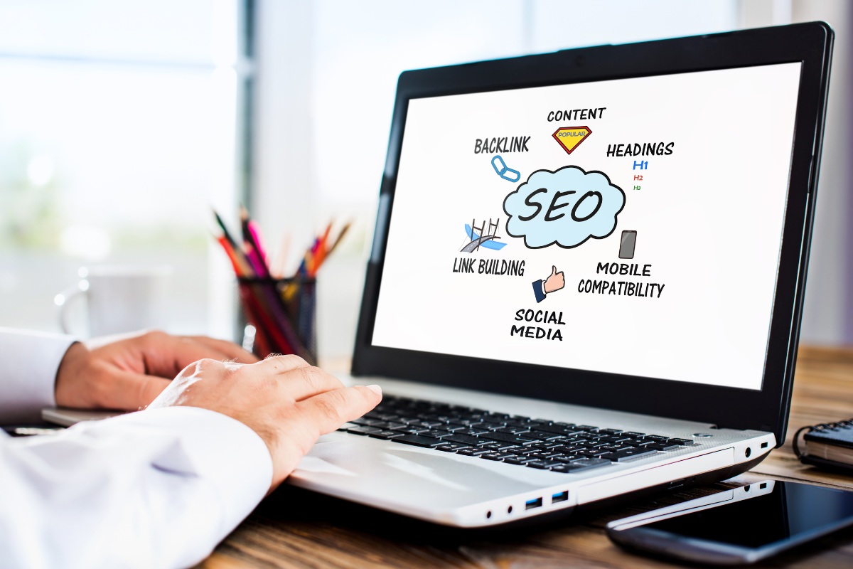 A man working on a laptop, demonstrating effective strategies to boost SEO conversions and improve online performance.